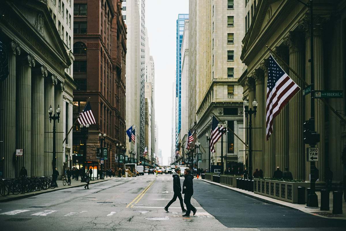 united states people walking on street near flag of U.S. America city